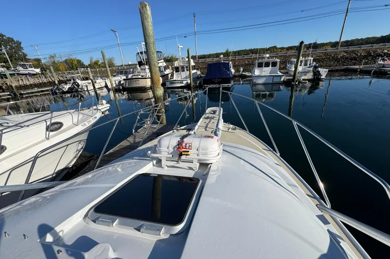 Slide: The Image of 1986 Luhrs Tournament 290 boat docked in a marina, surrounded by other vessels. - 18