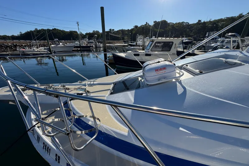 Slide: The Image of 1986 Luhrs Tournament 290 boat docked in a marina under clear blue skies. - 6