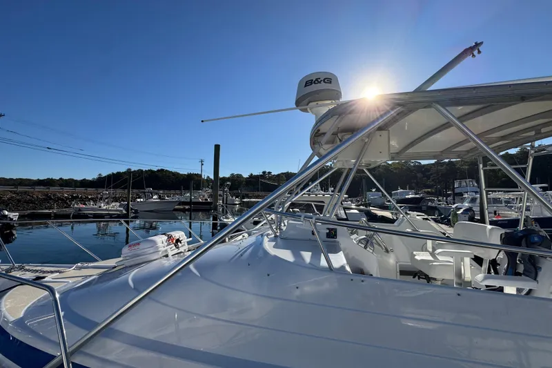 Slide: The Image of 1986 Luhrs Tournament 290 boat docked in sunny marina, showcasing sleek design and equipment. - 7