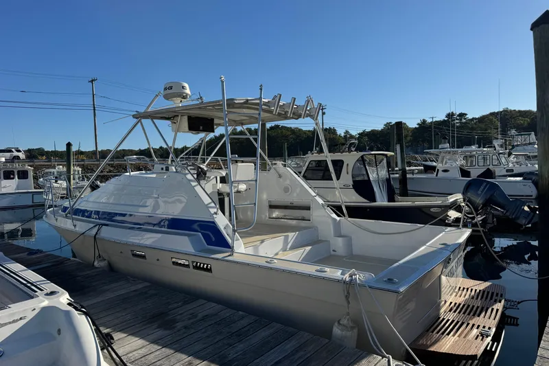 Slide: The Image of 1986 Luhrs Tournament 290 boat docked at a marina under clear blue skies. - 9