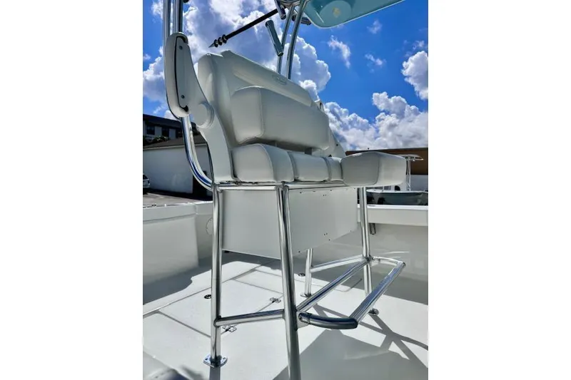 Slide: The Image of 2026 Pair Customs 24 Center Console DV boat seating under blue sky. - 11