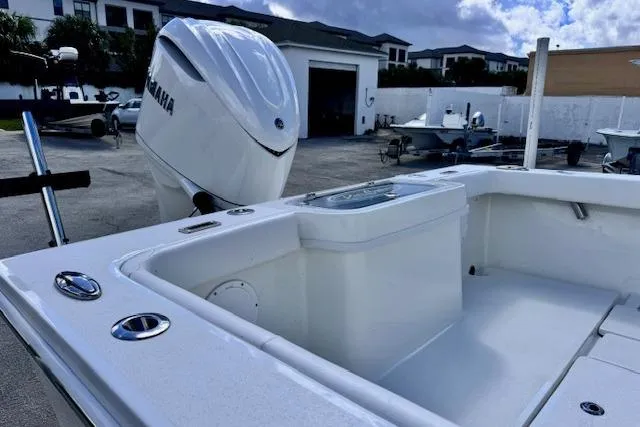 Slide: The Image of 2026 Pair Customs 24 Center Console DV boat with Yamaha engine in a marina setting. - 13