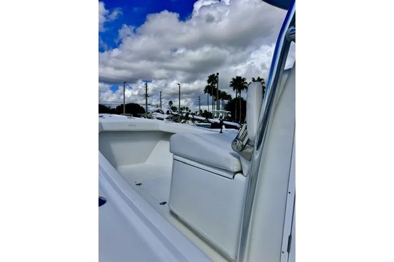 Slide: The Image of 2026 Pair Customs 24 Center Console DV boat under cloudy sky, showcasing sleek design. - 16