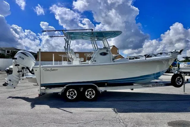 Slide: The Image of 2026 Pair Customs 24 Center Console DV boat on trailer under blue sky. - 6