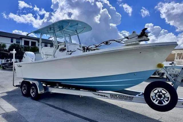 Slide: The Image of 2026 Pair Customs 24 Center Console DV boat on trailer under cloudy sky. - 7