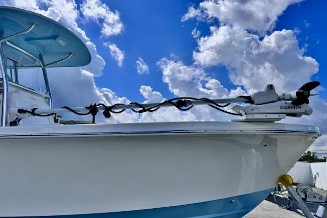 Slide: The Image of 2026 Pair Customs 24 Center Console DV boat with Garmin equipment under a blue sky. - 8