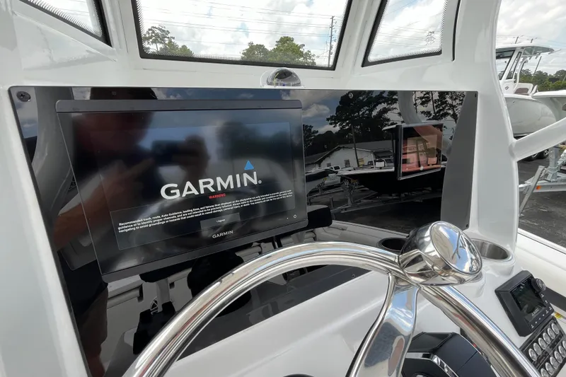 Slide: The Image of 2023 Tidewater 2500 Carolina Bay boat with Garmin navigation display at helm. - 17