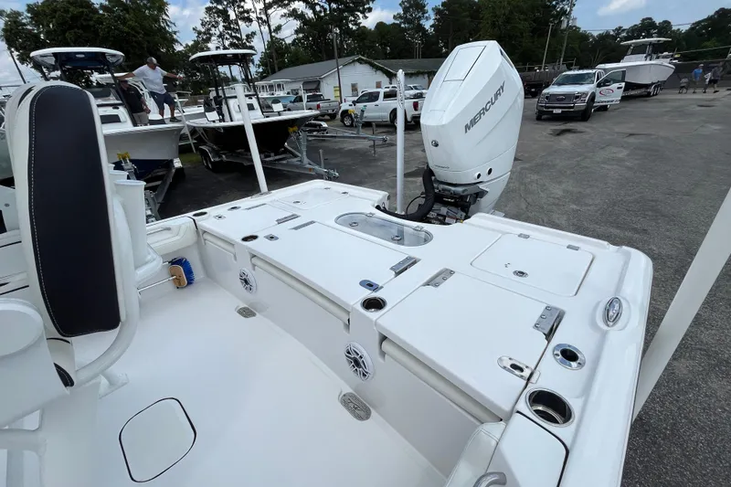 Slide: The Image of 2023 Tidewater 2500 Carolina Bay boat with Mercury engine, parked in a marina. - 18