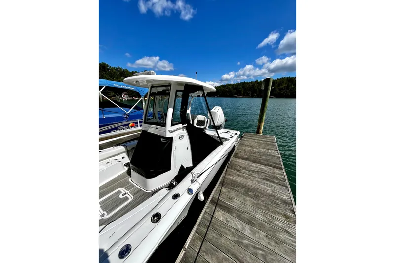 Slide: The Image of 2023 Tidewater 2500 Carolina Bay boat docked on a sunny day. - 21