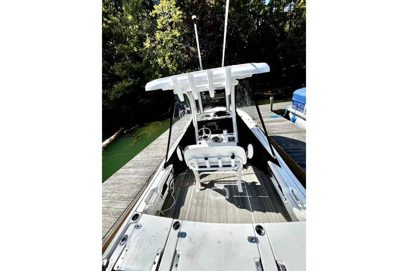 Slide: The Image of 2023 Tidewater 2500 Carolina Bay boat docked, featuring spacious deck and modern design. - 22