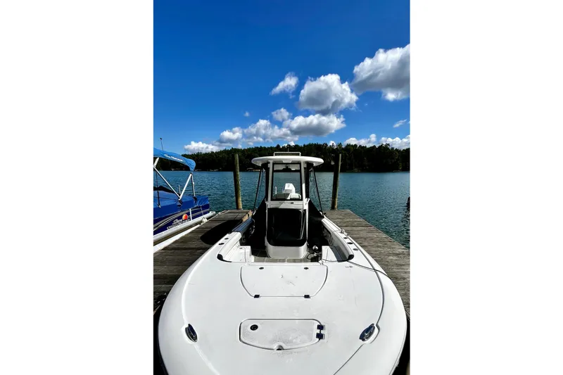 Slide: The Image of 2023 Tidewater 2500 Carolina Bay boat docked on a sunny day with blue skies. - 23
