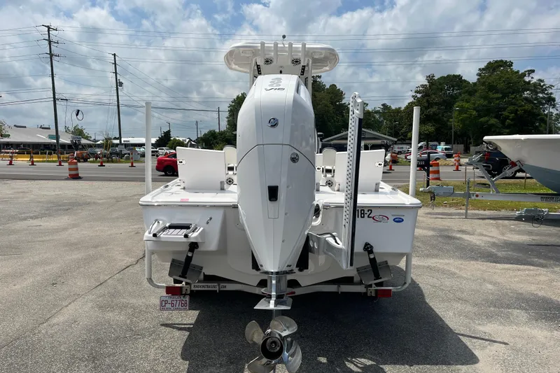 Slide: The Image of 2023 Tidewater 2500 Carolina Bay boat with powerful outboard motor, parked outdoors. - 3