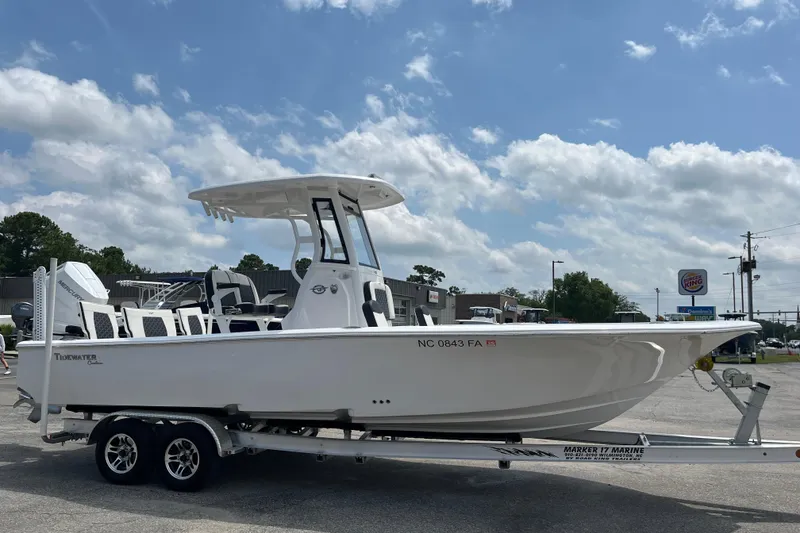 Slide: The Image of 2023 Tidewater 2500 Carolina Bay boat on trailer under cloudy sky. - 5