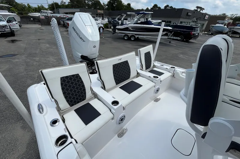 Slide: The Image of 2023 Tidewater 2500 Carolina Bay boat interior with seating and Mercury engine. - 6
