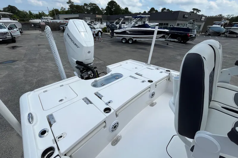 Slide: The Image of 2023 Tidewater 2500 Carolina Bay boat with Mercury engine, parked at a marina. - 7