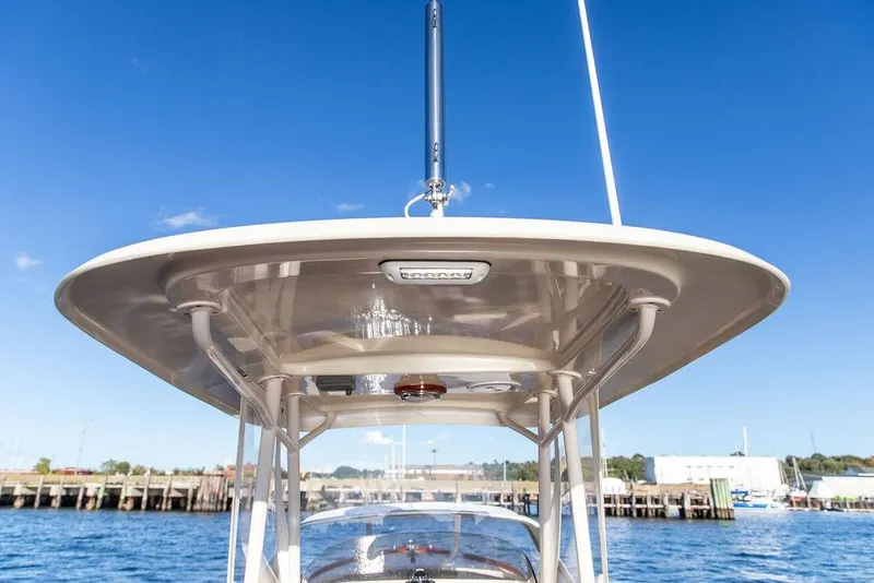 Slide: The Image of Hinckley Talaria 29C 2002 boat canopy against clear blue sky and waterfront. - 16