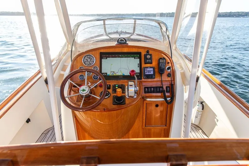 Slide: The Image of Helm of 2002 Hinckley Talaria 29C with wooden dashboard and navigation equipment. - 21