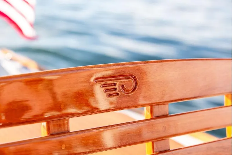 Slide: The Image of Teak deck detail of 2002 Hinckley Talaria 29C boat, showcasing elegant wood craftsmanship. - 28
