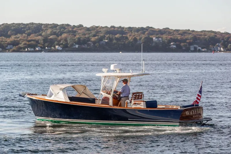 Slide: The Image of 2002 Hinckley Talaria 29C cruising on a scenic lake with wooded shoreline. - 3