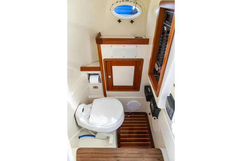 Slide: The Image of Control panel of a 2002 Hinckley Talaria 29C boat, featuring switches and gauges. - 32