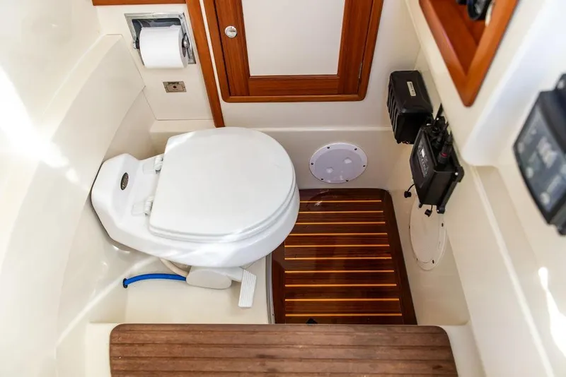 Slide: The Image of Hinckley Talaria 29C 2002 boat interior with toilet and wooden accents. - 33