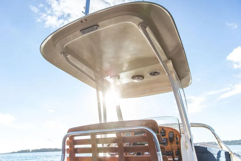 Slide: The Image of 2002 Hinckley Talaria 29C boat helm with sunlit canopy and clear blue sky. - 14