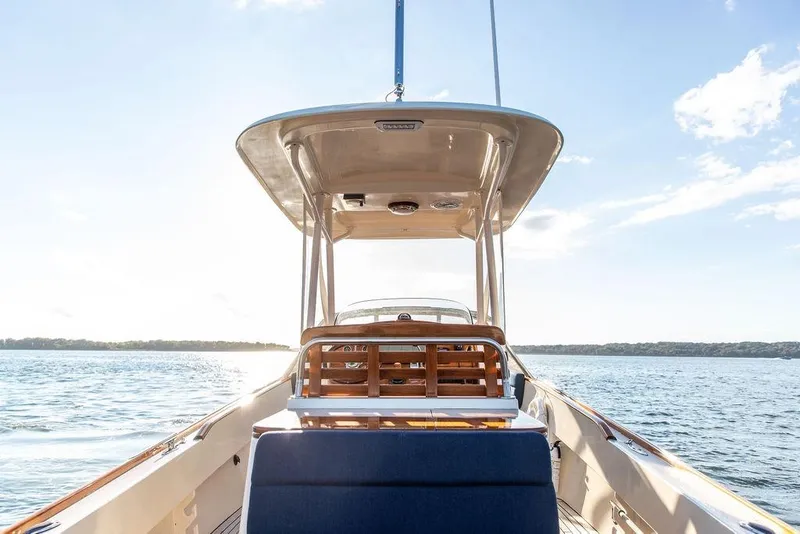 Slide: The Image of 2002 Hinckley Talaria 29C boat on calm water under clear sky. - 15