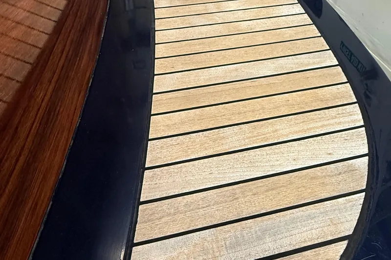 Slide: The Image of Hinckley Talaria 29C boat, 2002 model, with "Wayfarer" name and American flag, on water. - 35