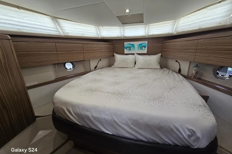 Slide: The Image of Luxurious bedroom interior of 2019 Greenline 40 yacht with elegant wood paneling. - 10