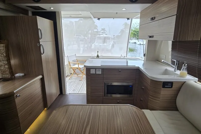 Slide: The Image of Interior of 2019 Greenline 40 yacht with modern kitchen and outdoor view. - 16