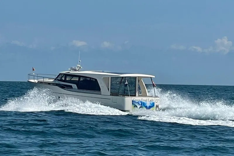 Slide: The Image of 2019 Greenline 40 yacht cruising on open sea with waves. - 2