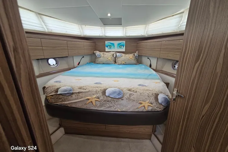 Slide: The Image of Luxurious cabin interior of 2019 Greenline 40 yacht with beach-themed bedding. - 22
