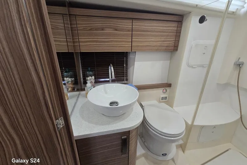Slide: The Image of Luxurious bathroom in 2019 Greenline 40 yacht with modern fixtures and wood accents. - 23