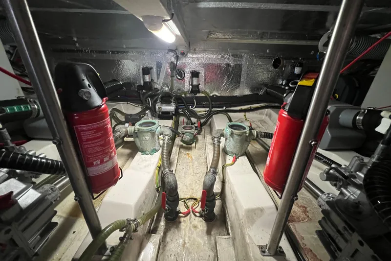 Slide: The Image of Engine room of 2019 Greenline 40 yacht with fire extinguishers and mechanical components. - 25