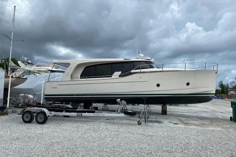 Slide: The Image of 2019 Greenline 40 yacht on trailer under cloudy sky at marina. - 5