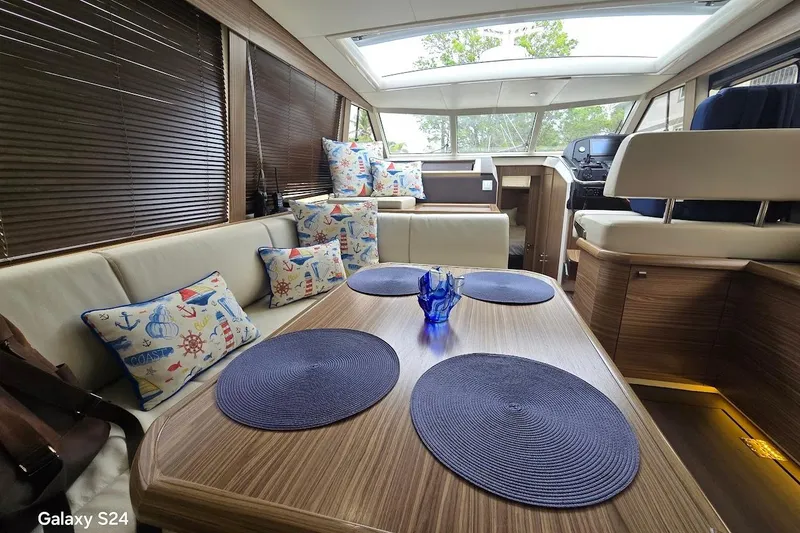 Slide: The Image of Interior of 2019 Greenline 40 yacht with nautical-themed cushions and modern decor. - 9