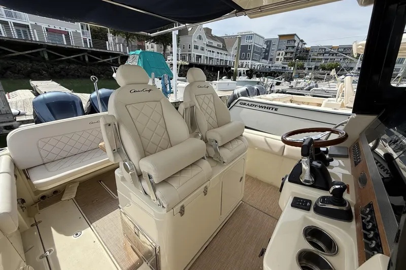 Slide: The Image of 2019 Chris-Craft Catalina 30 boat interior with luxurious seating and control panel. - 11