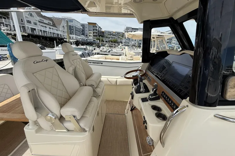 Slide: The Image of Interior of 2019 Chris-Craft Catalina 30 boat with luxurious seating and modern dashboard. - 12