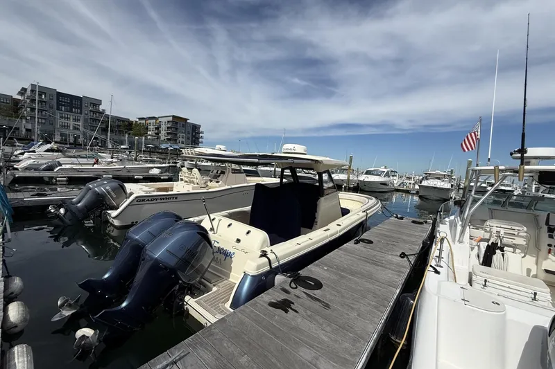 Slide: The Image of 2019 Chris-Craft Catalina 30 docked at marina with other boats, under a clear sky. - 3