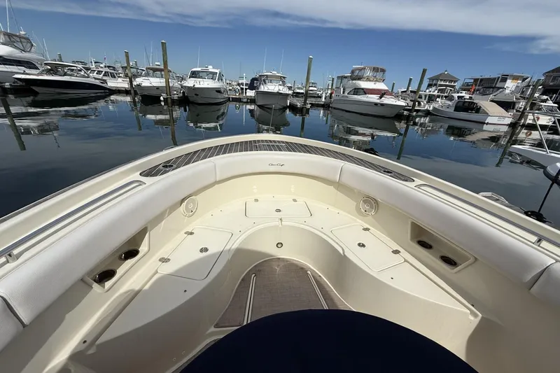 Slide: The Image of 2019 Chris-Craft Catalina 30 boat docked in a marina, surrounded by other vessels. - 6