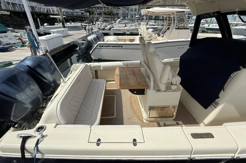 Slide: The Image of 2019 Chris-Craft Catalina 30 boat interior with seating and table at marina. - 8