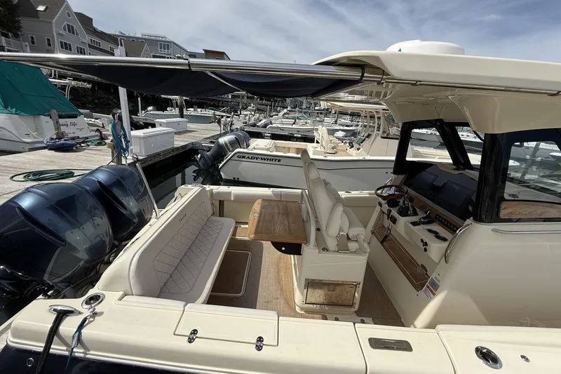 Slide: The Image of 2019 Chris-Craft Catalina 30 boat interior at marina, featuring seating and control panel. - 9