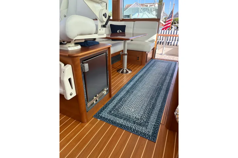 Slide: The Image of Interior of 2023 Sabre 45 Salon Express with TV and nautical-themed pillow. - 11