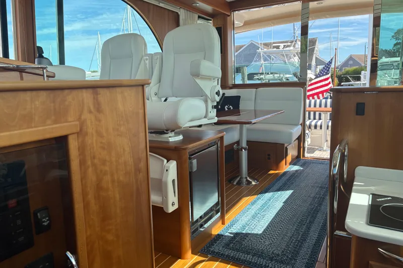 Slide: The Image of Luxurious wooden table on 2023 Sabre 45 Salon Express yacht interior. - 14