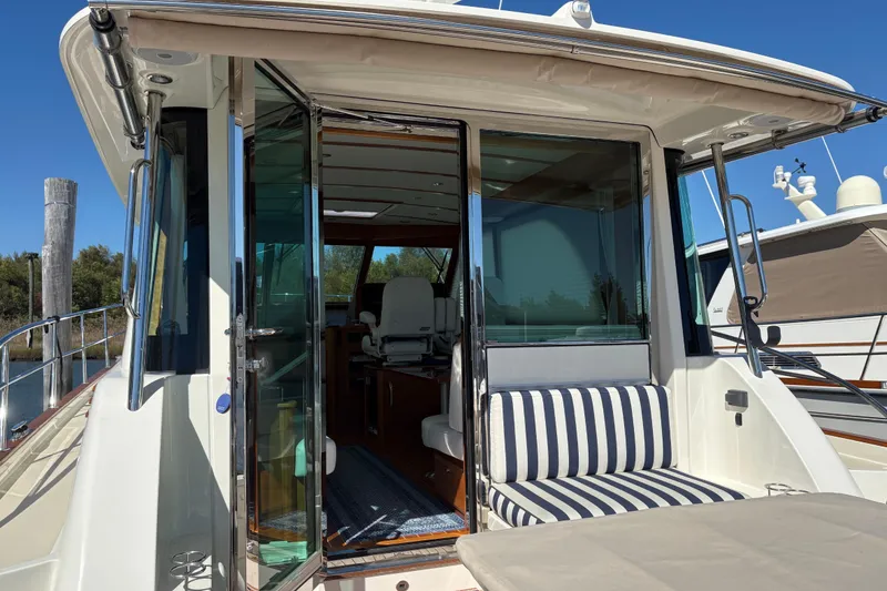 Slide: The Image of 2023 Sabre 45 Salon Express yacht docked, featuring elegant design and modern amenities. - 2