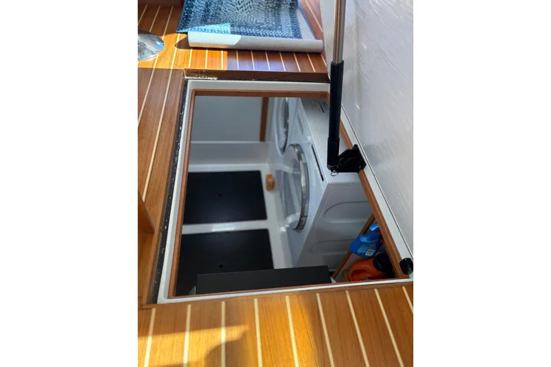 Slide: The Image of 2023 Sabre 45 Salon Express interior with open hatch and wooden flooring. - 26