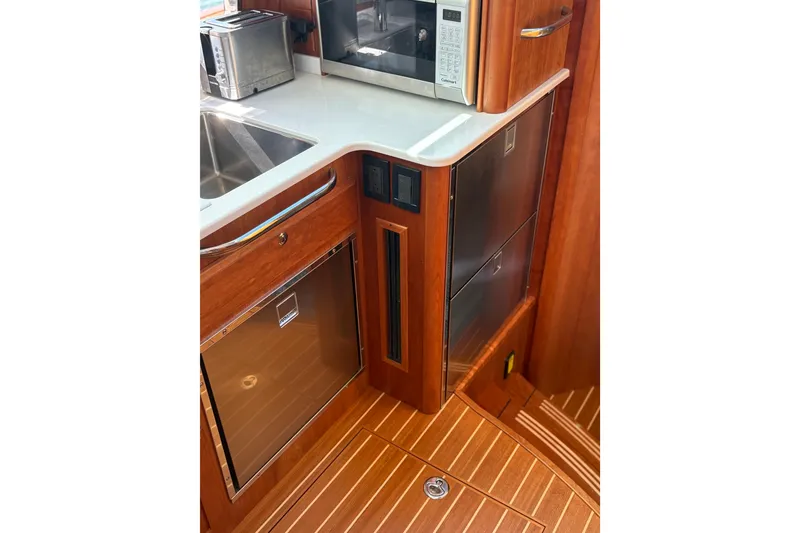 Slide: The Image of Modern kitchen in 2023 Sabre 45 Salon Express yacht with stove, sink, and microwave. - 29