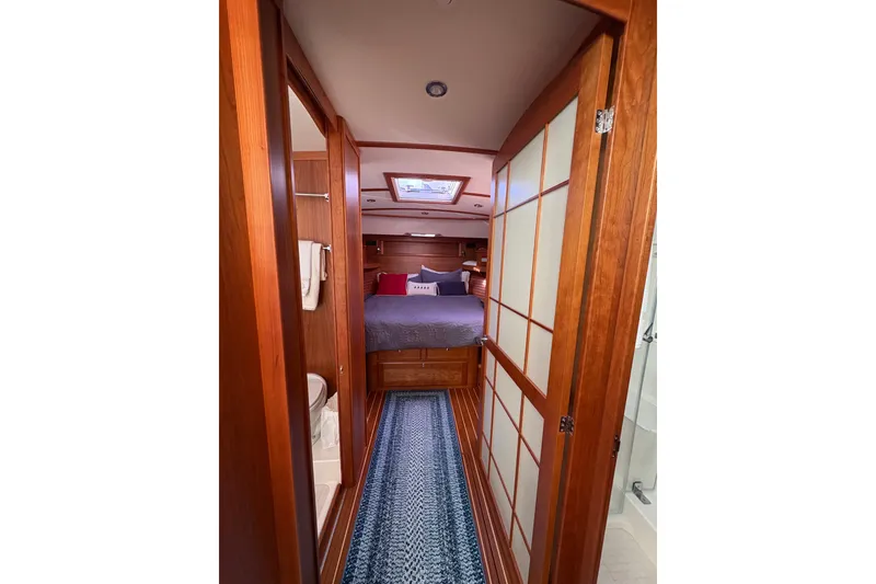 Slide: The Image of 2023 Sabre 45 Salon Express galley with wood cabinetry, stainless steel appliances, and modern fixtures. - 30