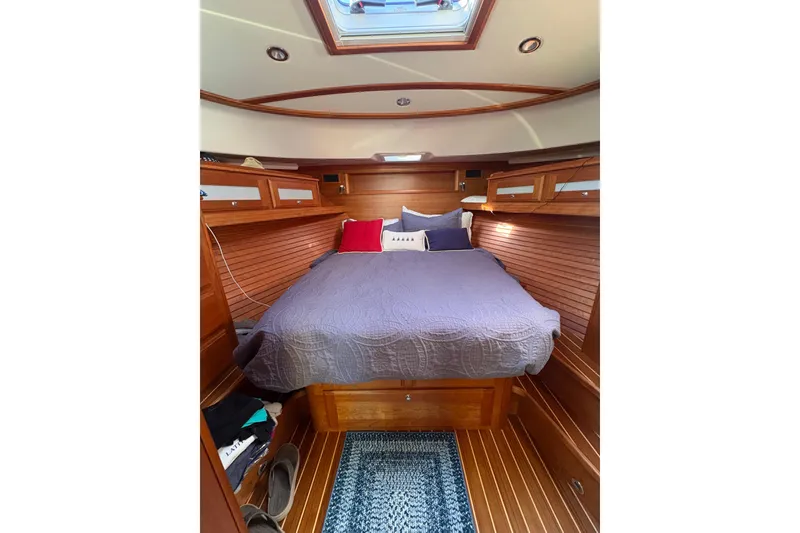 Slide: The Image of 2023 Sabre 45 Salon Express interior with wooden doors, cozy bedroom, and modern bathroom. - 32