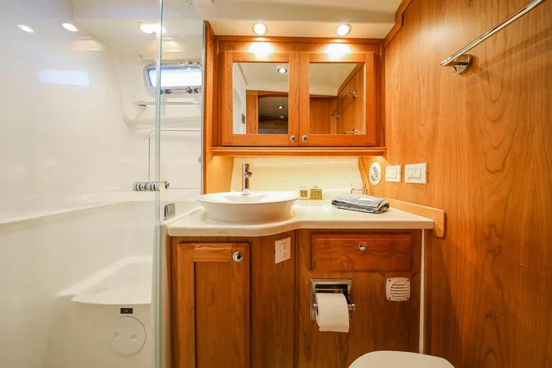 Slide: The Image of 2023 Sabre 45 Salon Express cabin with wooden cabinetry and cozy bedding. - 36